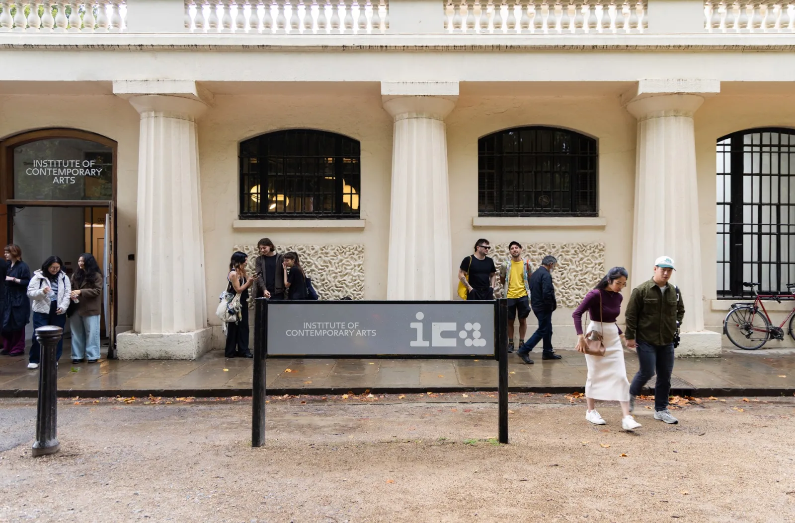 The ICA's street-level entrance on The Mall beneath Nash House, with fluted columns, an arched doorway lettered Institute of Contemporary Arts and a freestanding ICA sign in front