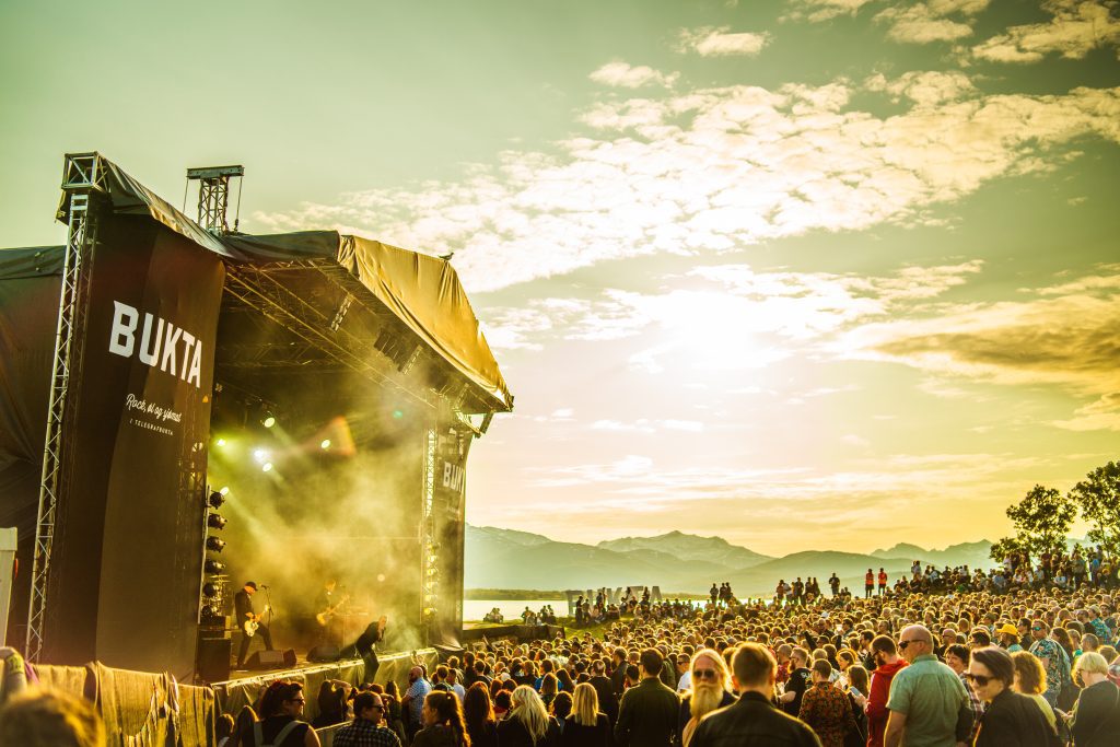 Photo of Bukta stage and crowd with a sunset look. 